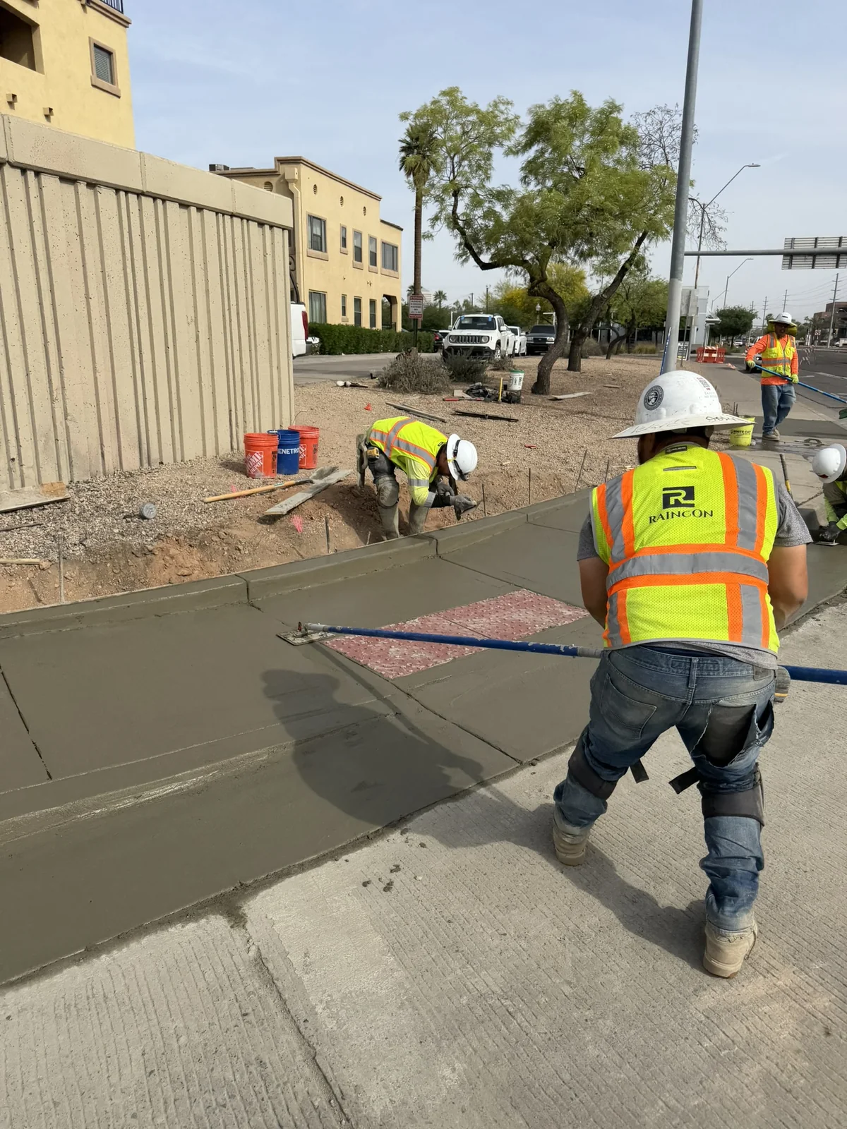 Raincon concrete worker finishing a daytime pour