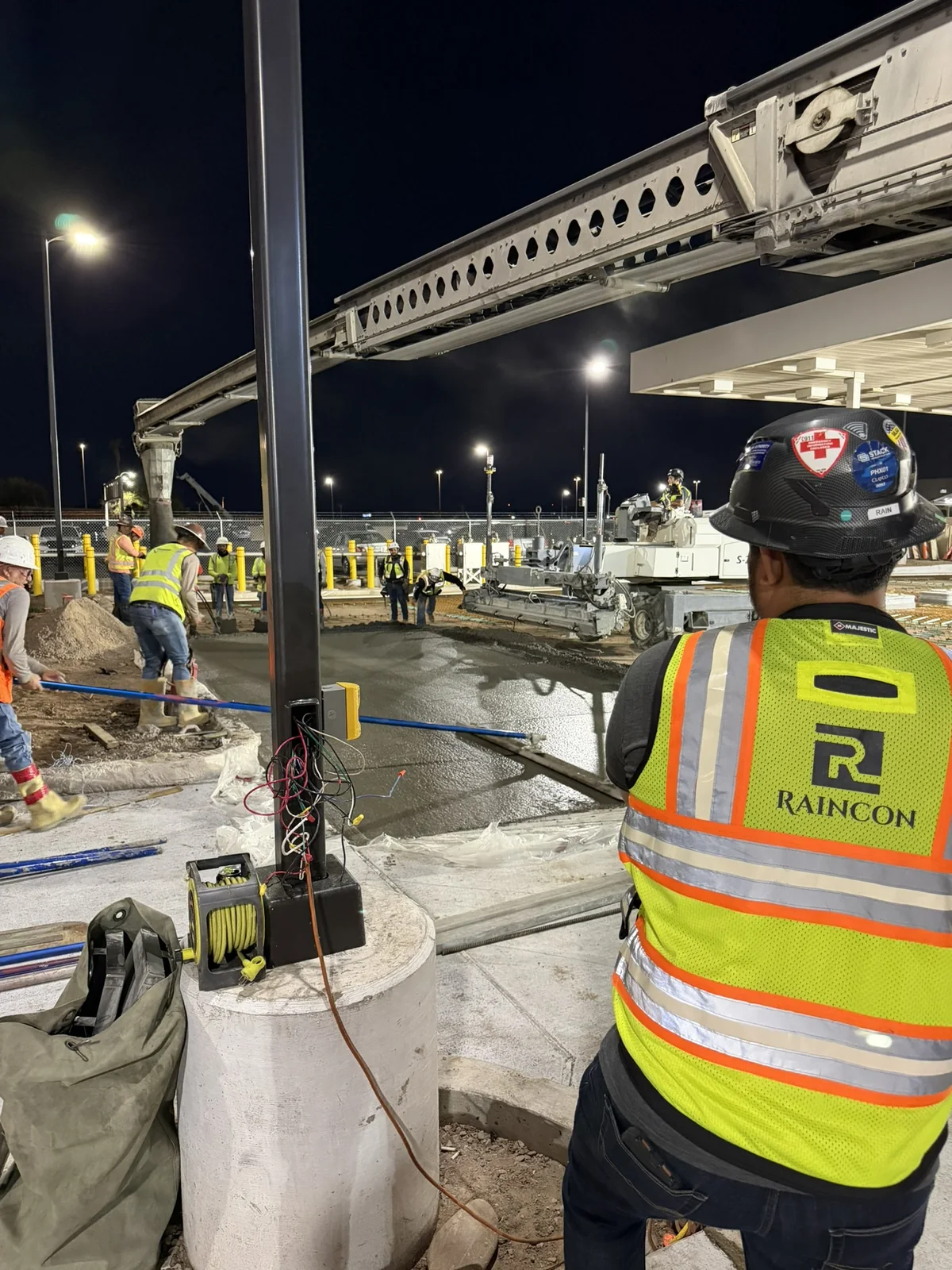 Raincon crew member overseeing concrete work at night